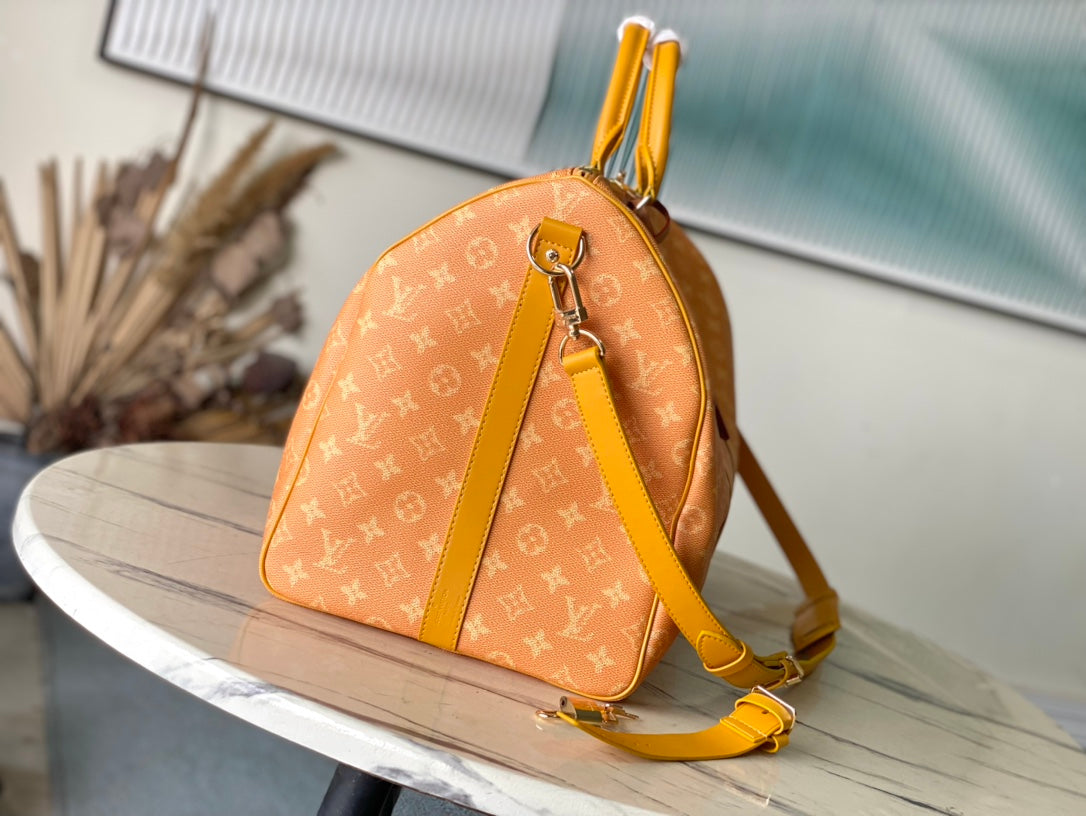 LOUIS VUITTON KEEPALL BANDOULIÈRE 55 IN ORANGE MONOGRAM HERITAGE CANVAS